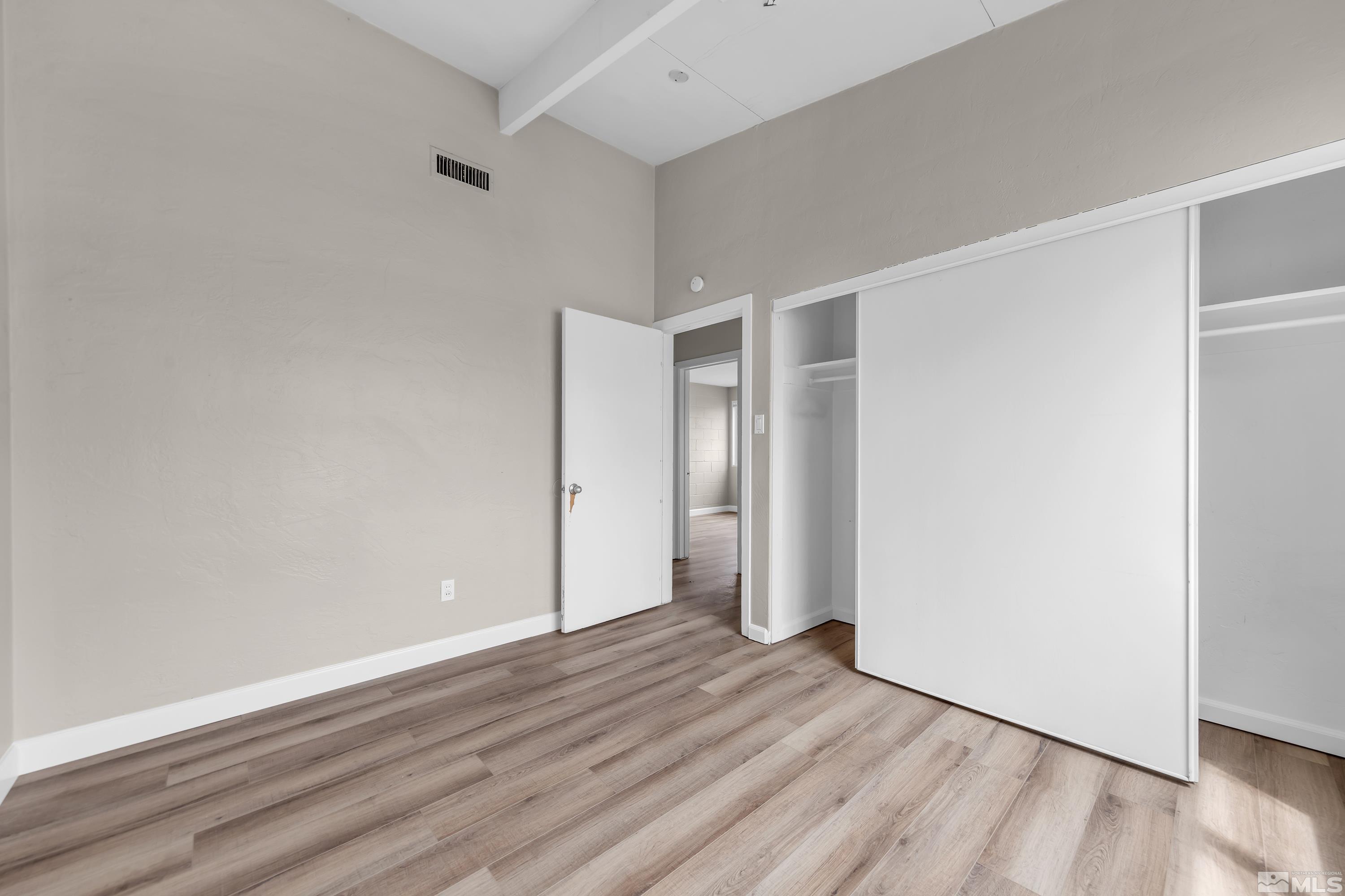 12190 Himalaya Street Reno, NV 89506 - Photo 19 of 34 a view of an empty room with wooden floor