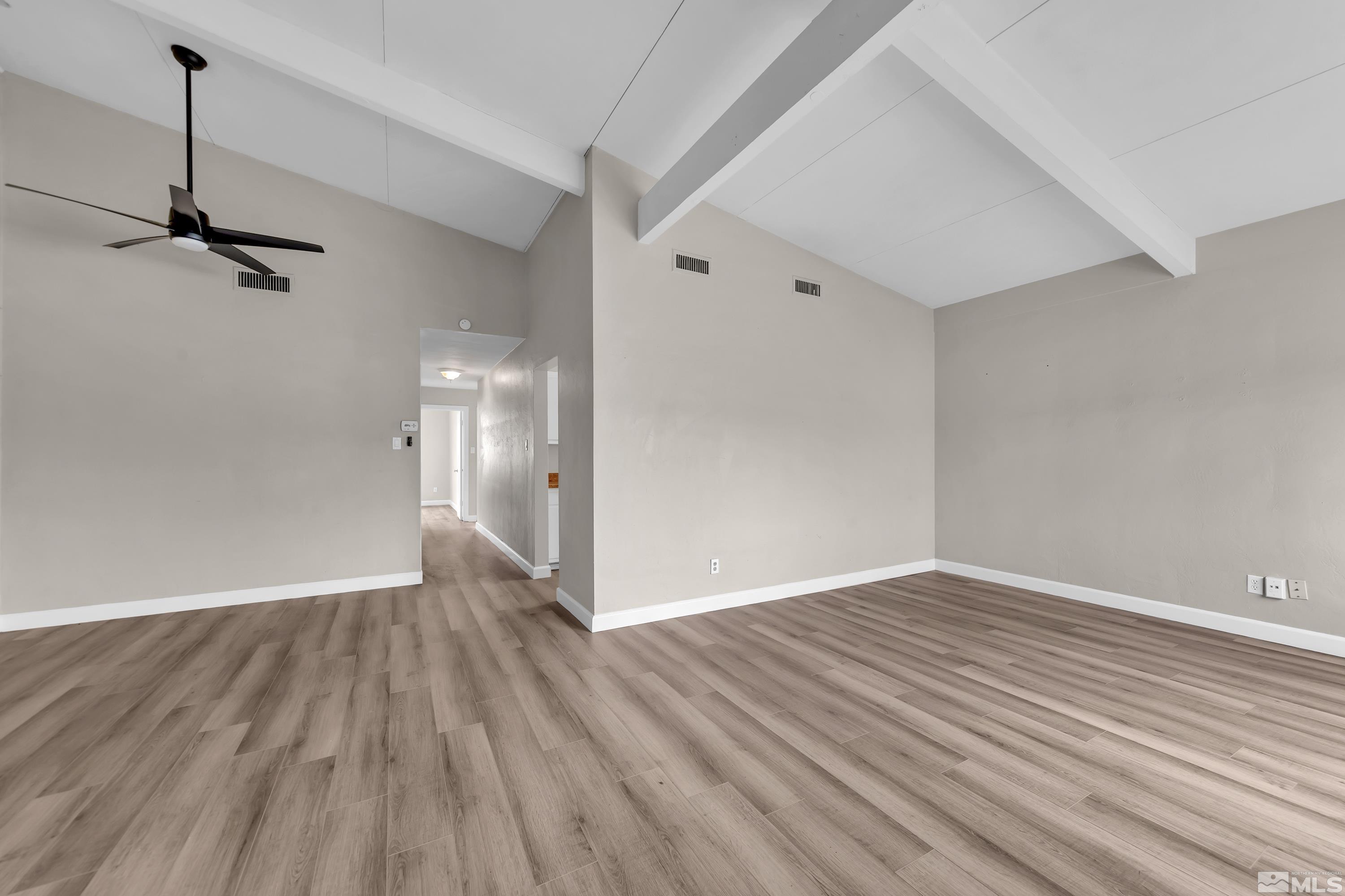 12190 Himalaya Street Reno, NV 89506 - Photo 5 of 34 a view of an empty room with wooden floor