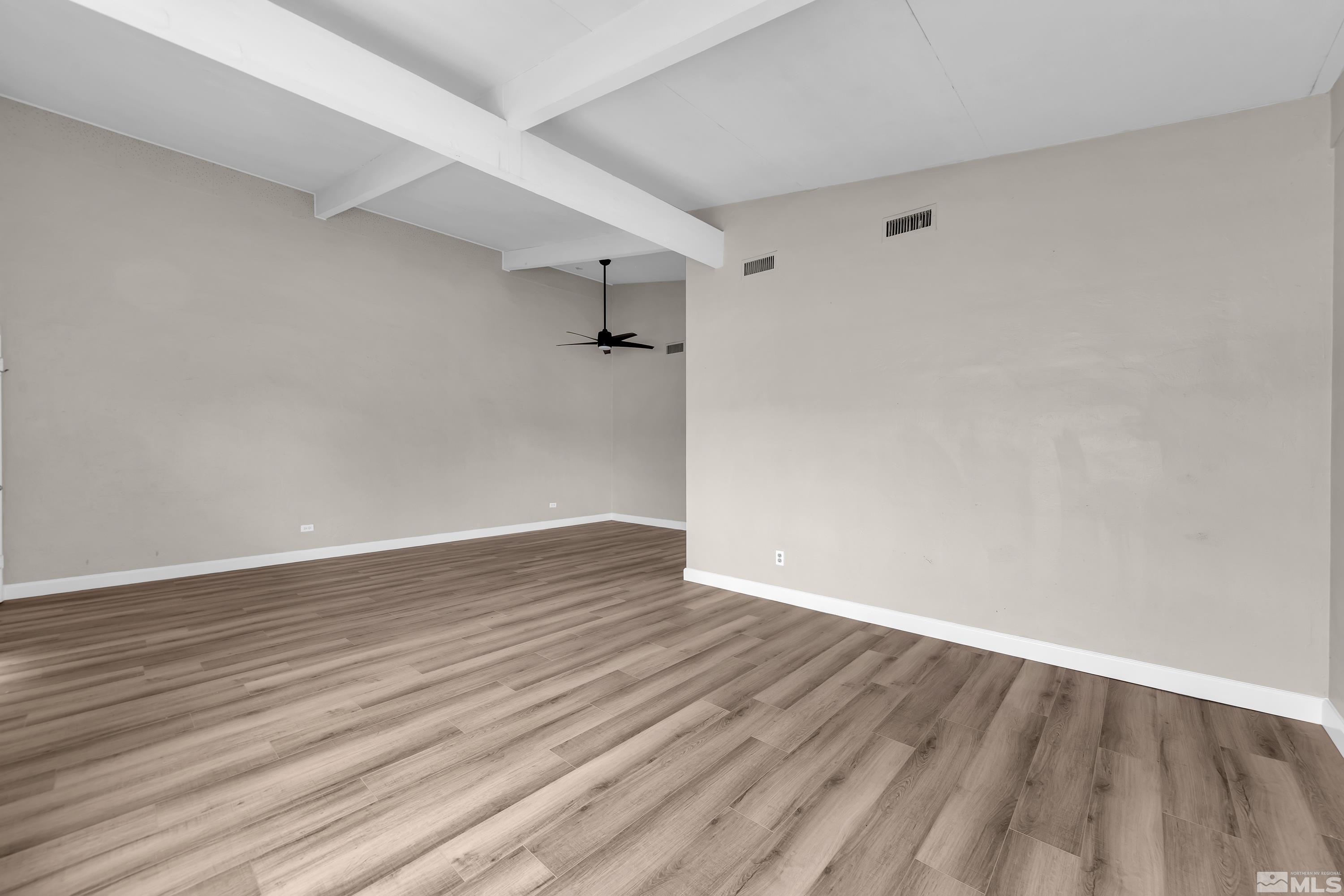 12190 Himalaya Street Reno, NV 89506 - Photo 6 of 34 a view of an empty room with wooden floor