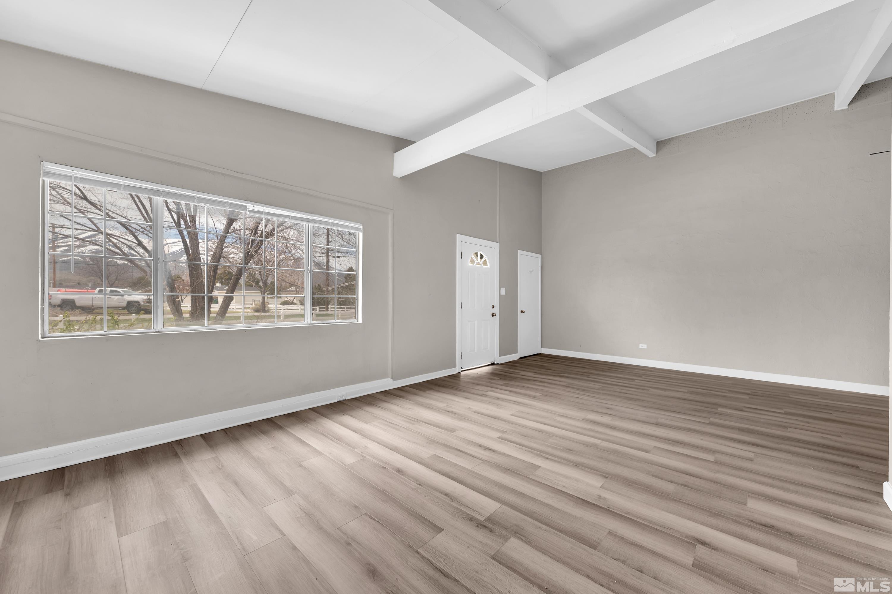 12190 Himalaya Street Reno, NV 89506 - Photo 7 of 34 a view of an empty room with wooden floor and a window