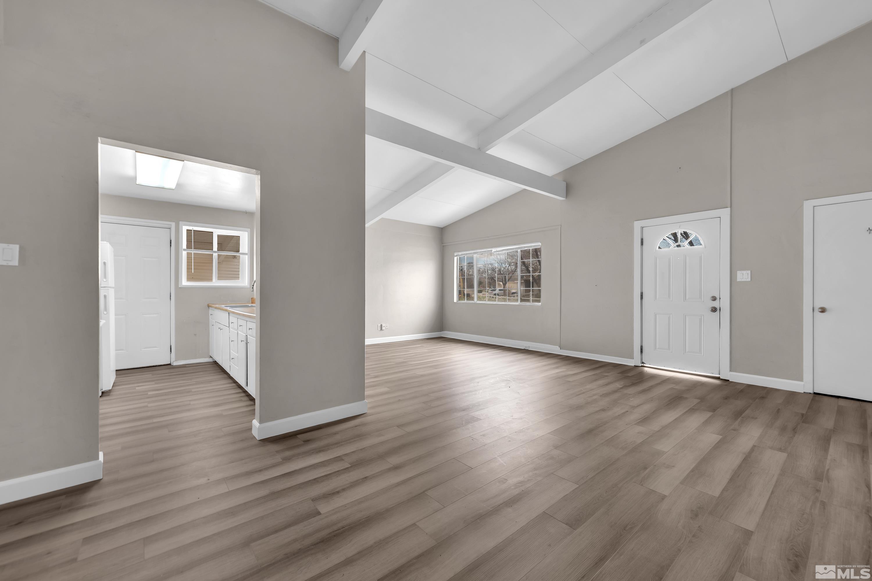 12190 Himalaya Street Reno, NV 89506 - Photo 8 of 34 an empty room with wooden floor and windows