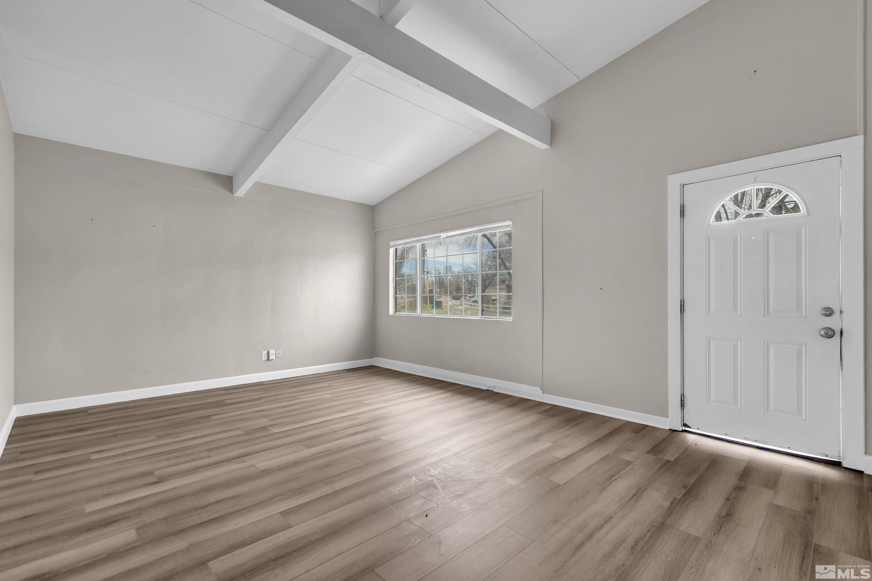 12190 Himalaya Street Reno, NV 89506 - Photo 9 of 34 an empty room with wooden floor and windows