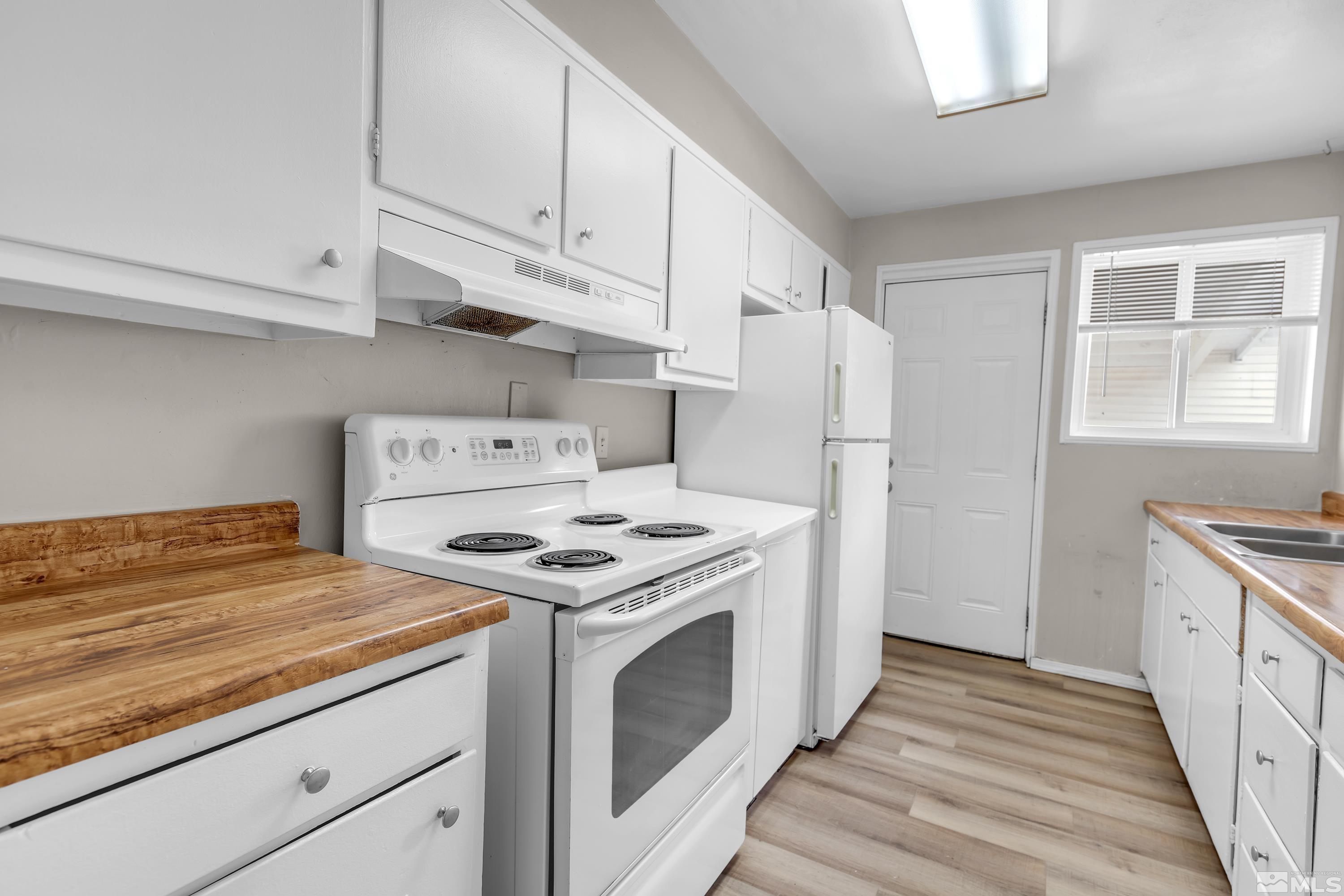 12190 Himalaya Street Reno, NV 89506 - Photo 10 of 34 a kitchen with a stove and a white wooden cabinets