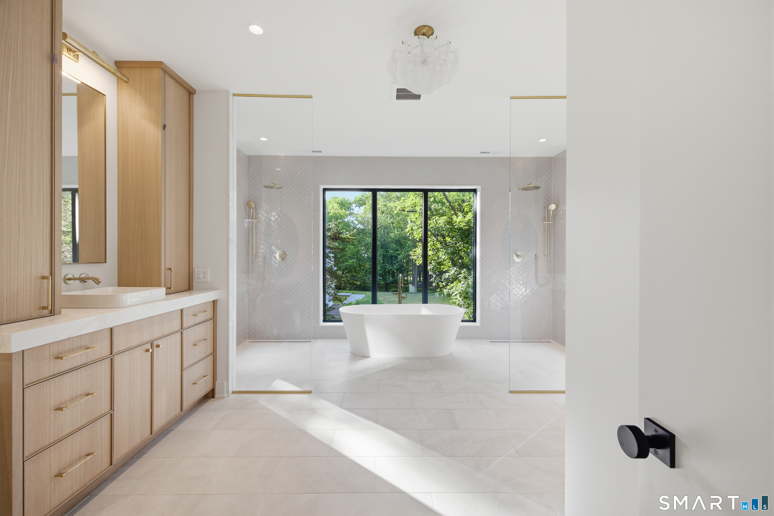 2 Windy Hill Road Westport, CT 06880 - Photo 19 of 40 a spacious bathroom with a double vanity sink a large mirror and a bathtub
