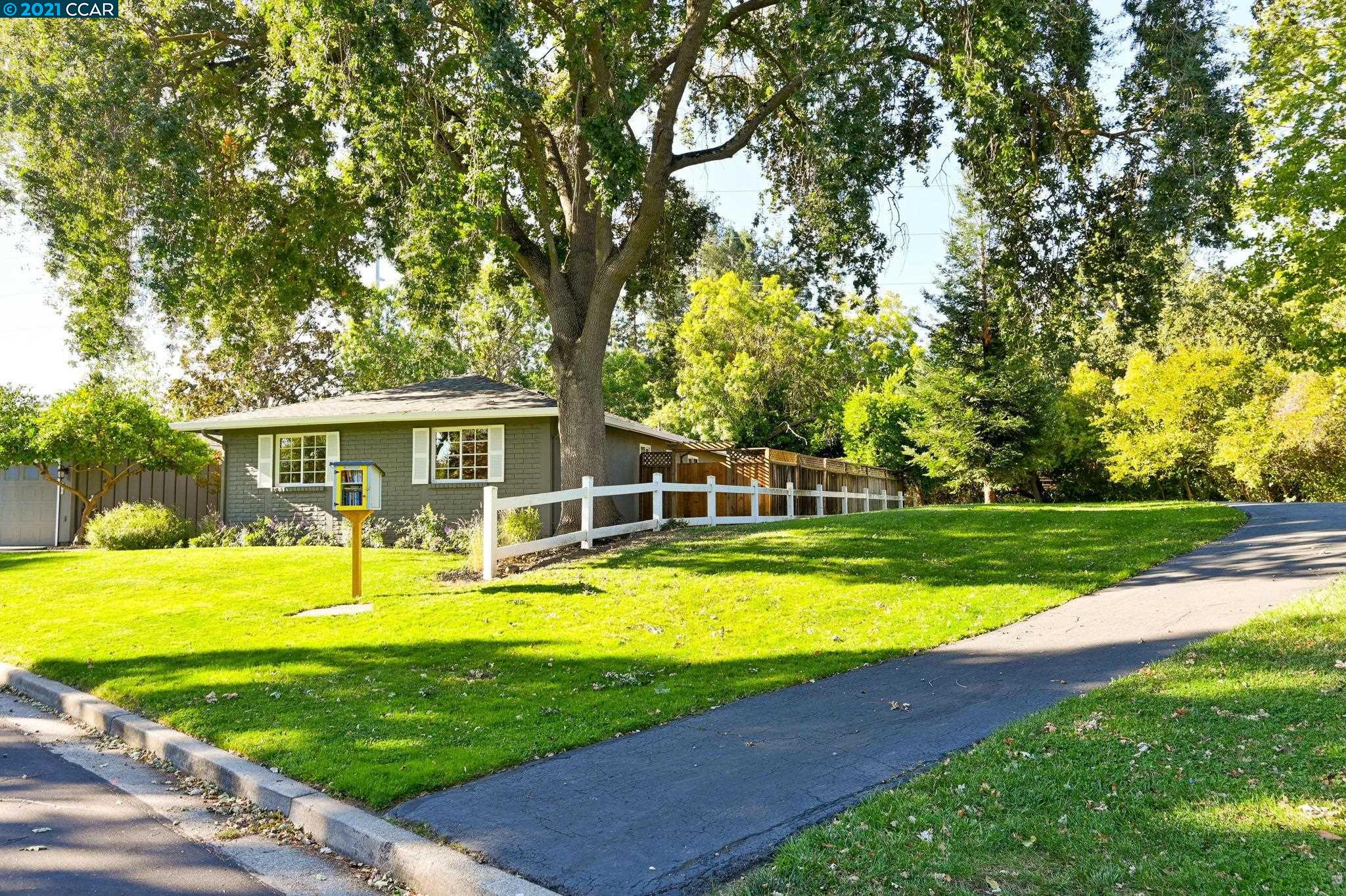 a view of a house with swimming pool and a yard