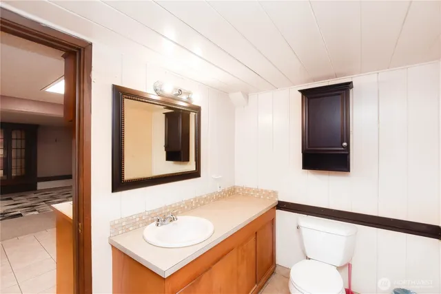 a bathroom with a toilet sink and mirror