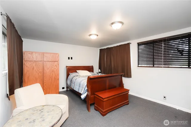 a bedroom with furniture and a window