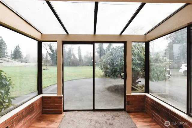 a view of an empty room with large windows