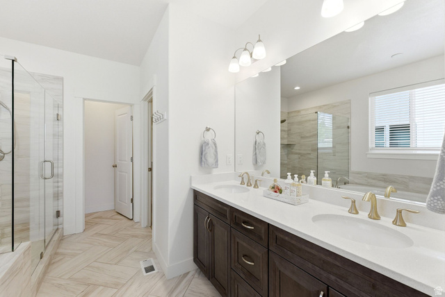 108 West Monte Rosa Lane Midway, UT 84049 - Photo 18 of 48 Double vanity with dark wood-finish cabinetry, white countertops, and gold-toned fixtures