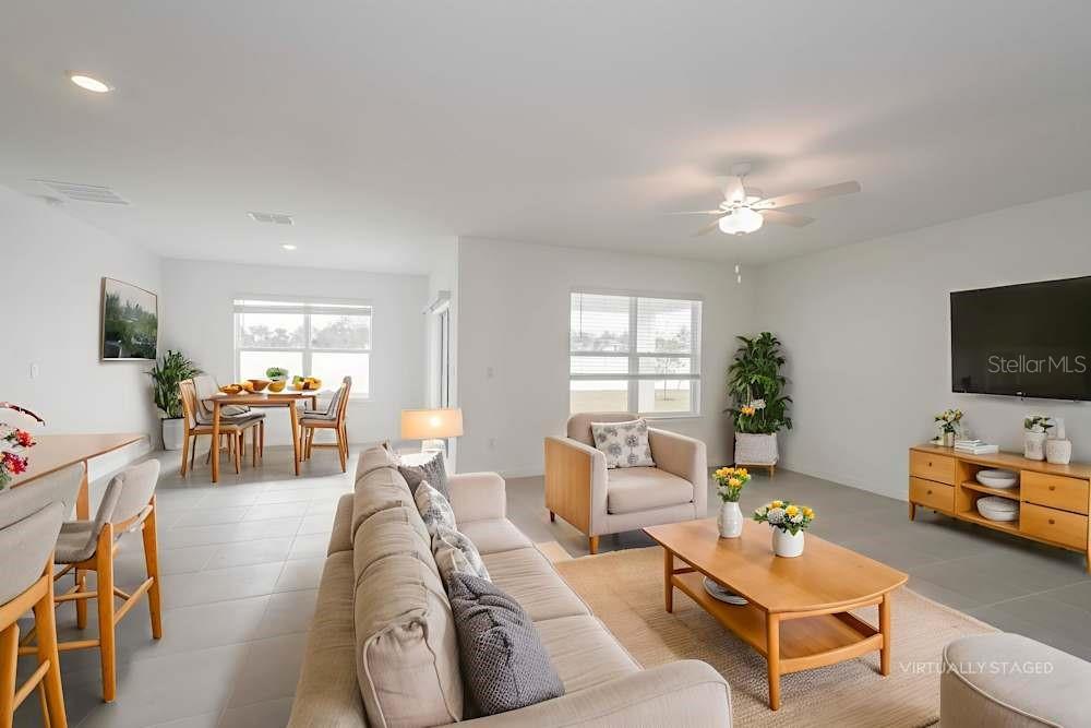 3688 Benham Rise Road Spring Hill, FL 34609 - Photo 3 of 6 a living room with furniture and a flat screen tv