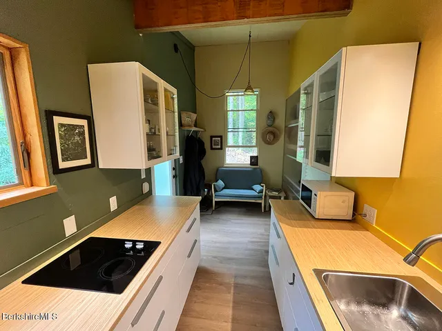 a kitchen with sink and cabinets