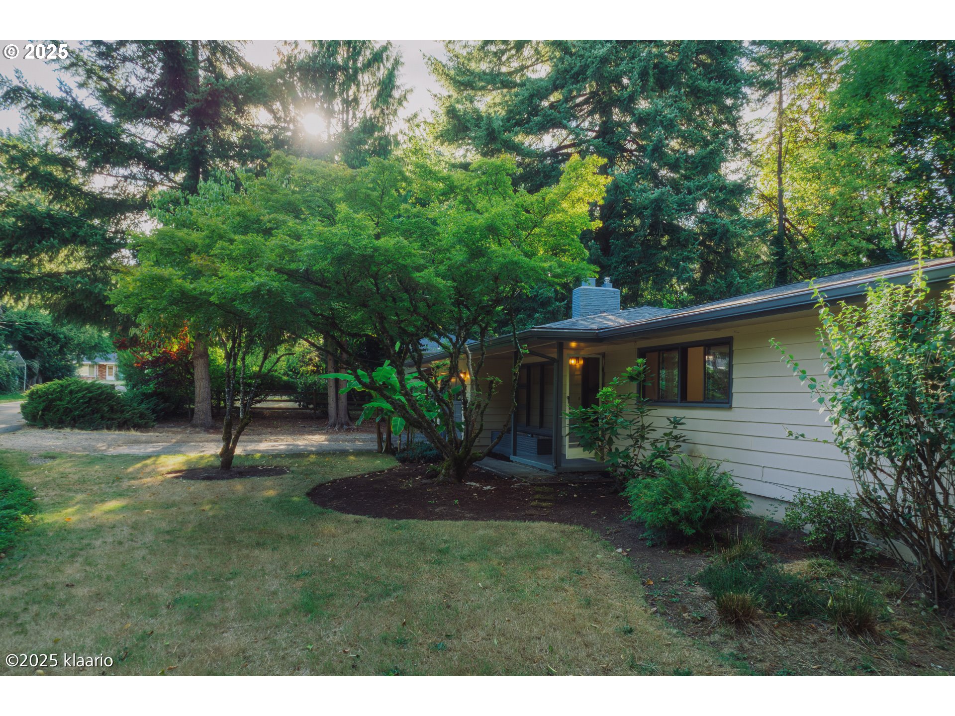 3691 Ridgewood Way West Linn, OR 97068 - Photo 31 of 34 a backyard of a house with plants and large trees
