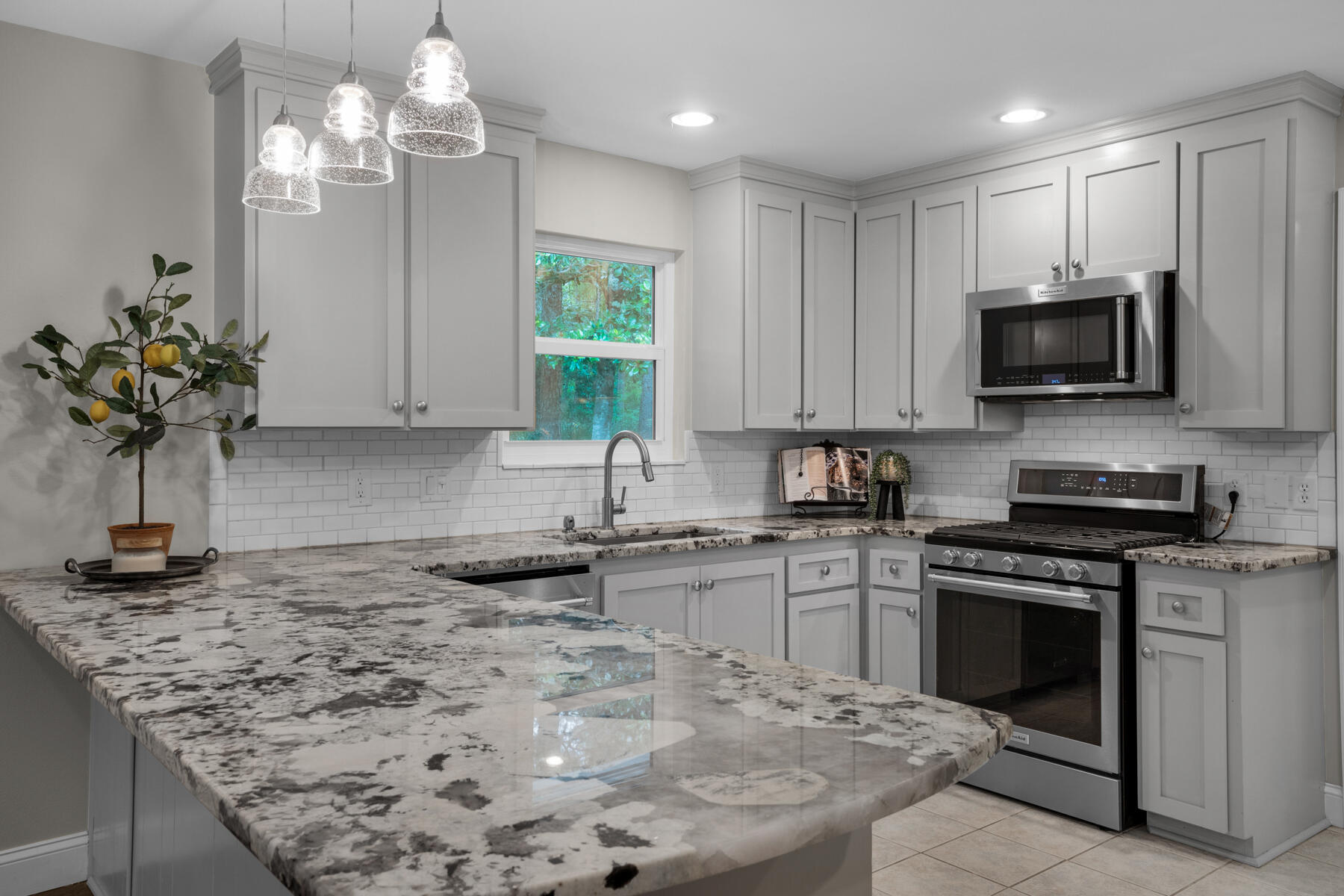 665 Brookhaven Way Niceville, FL 32578 - Photo 18 of 49 a kitchen with kitchen island granite countertop a sink a counter top space appliances and cabinets