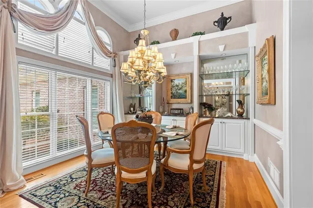 a view of a dining room with furniture and chandelier