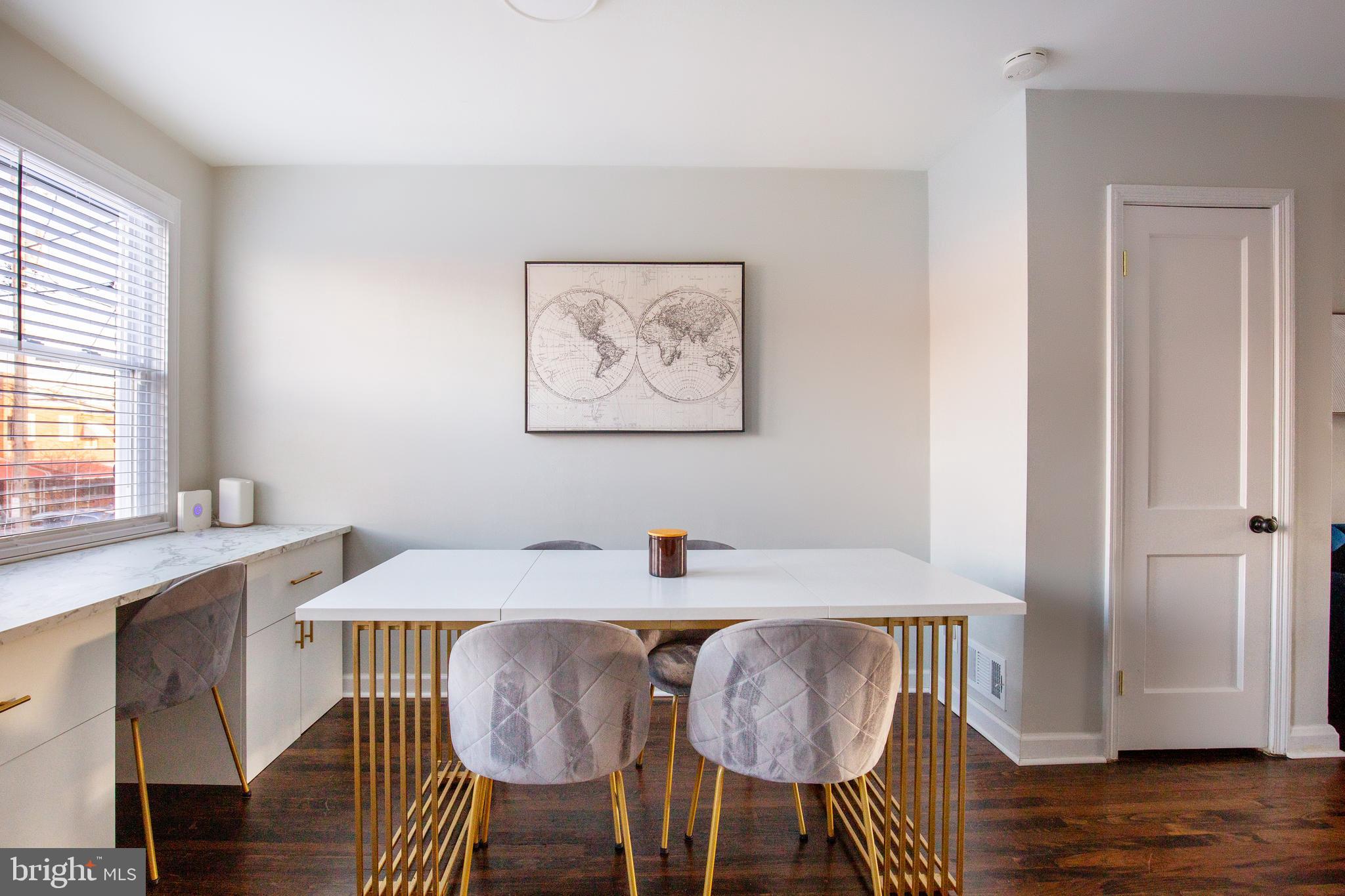 413 Imla Street Baltimore, MD 21224 - Photo 14 of 38 a view of a dining room with furniture and wooden floor