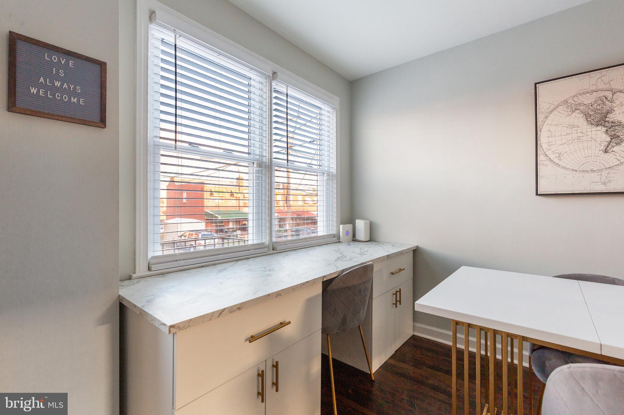 413 Imla Street Baltimore, MD 21224 - Photo 15 of 38 a view of a room that has a bed and a table in it