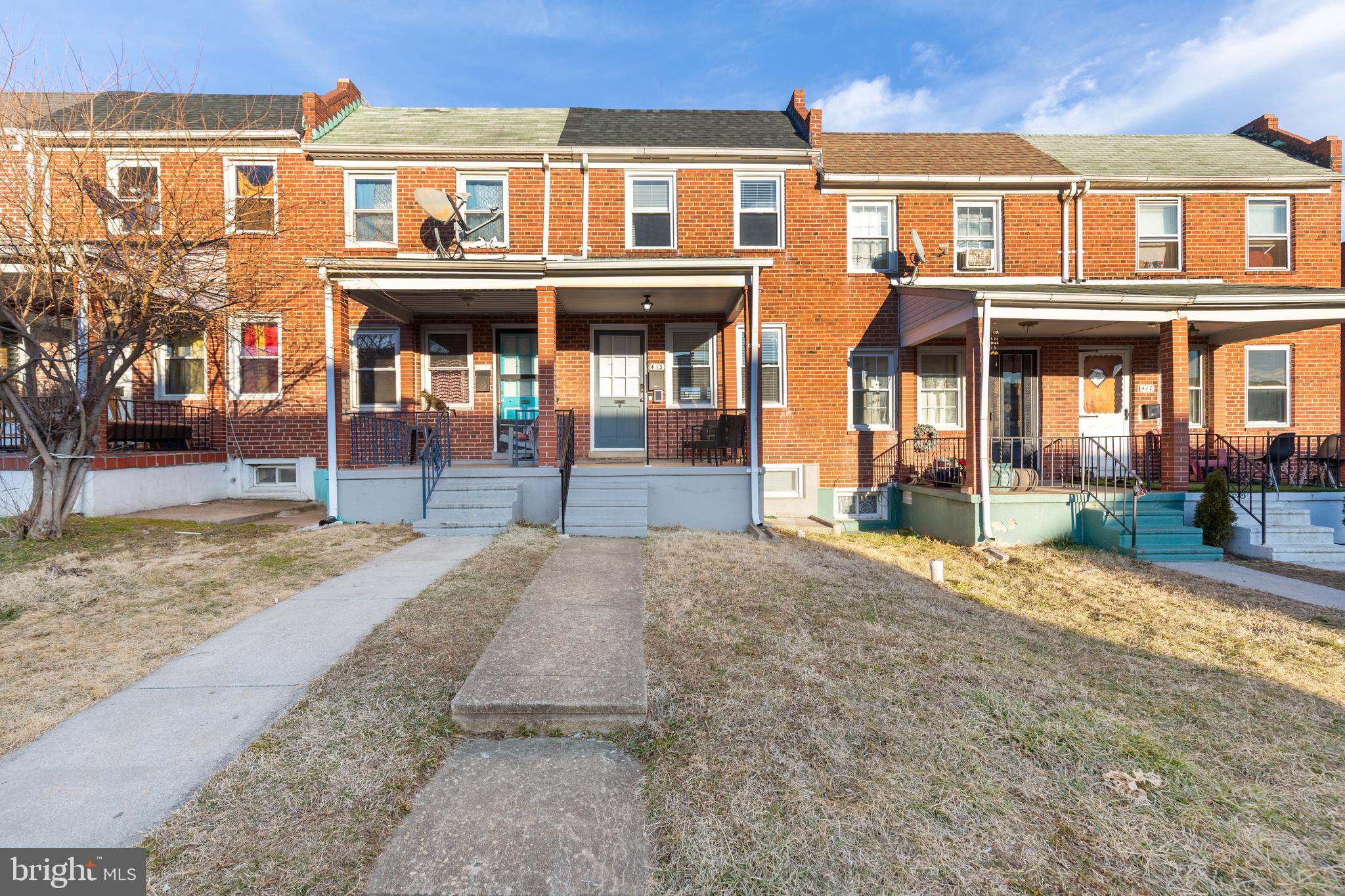413 Imla Street Baltimore, MD 21224 - Photo 3 of 38 a front view of a building and a yard