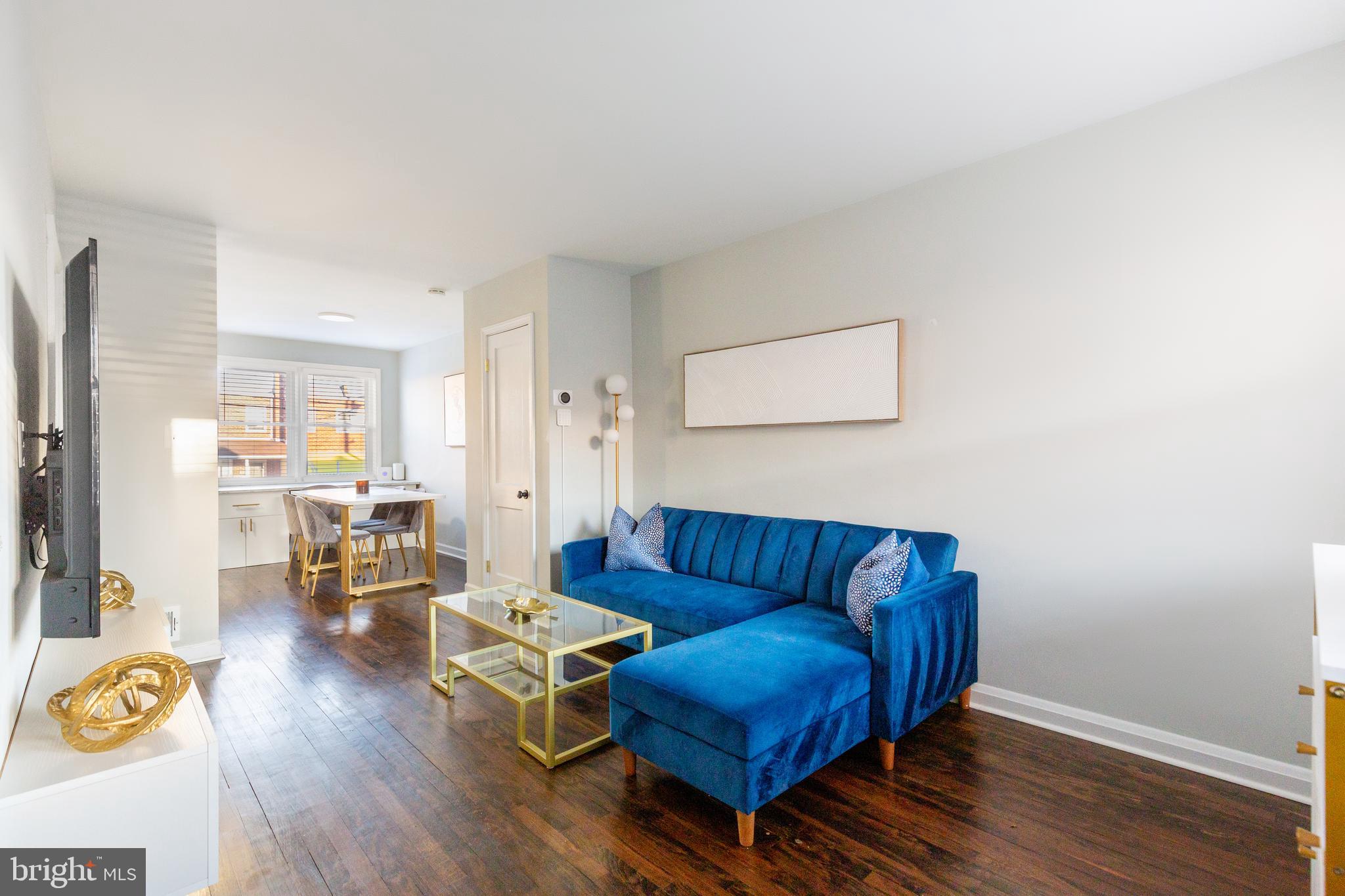 413 Imla Street Baltimore, MD 21224 - Photo 7 of 38 a living room with furniture wooden floor and a window