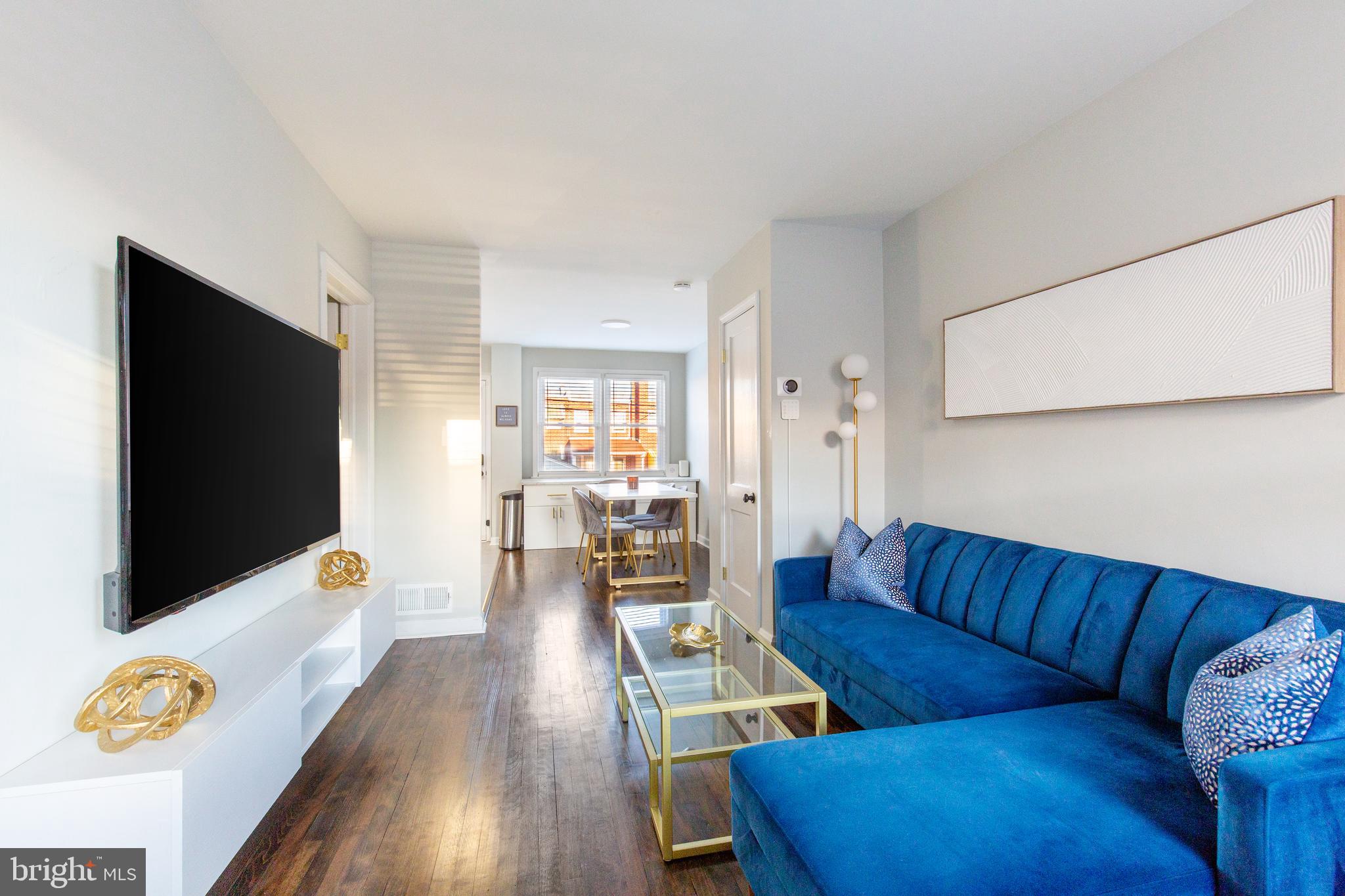 413 Imla Street Baltimore, MD 21224 - Photo 8 of 38 a living room with furniture and a flat screen tv