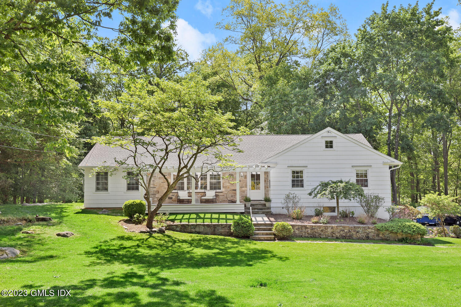 a front view of house with yard and green space