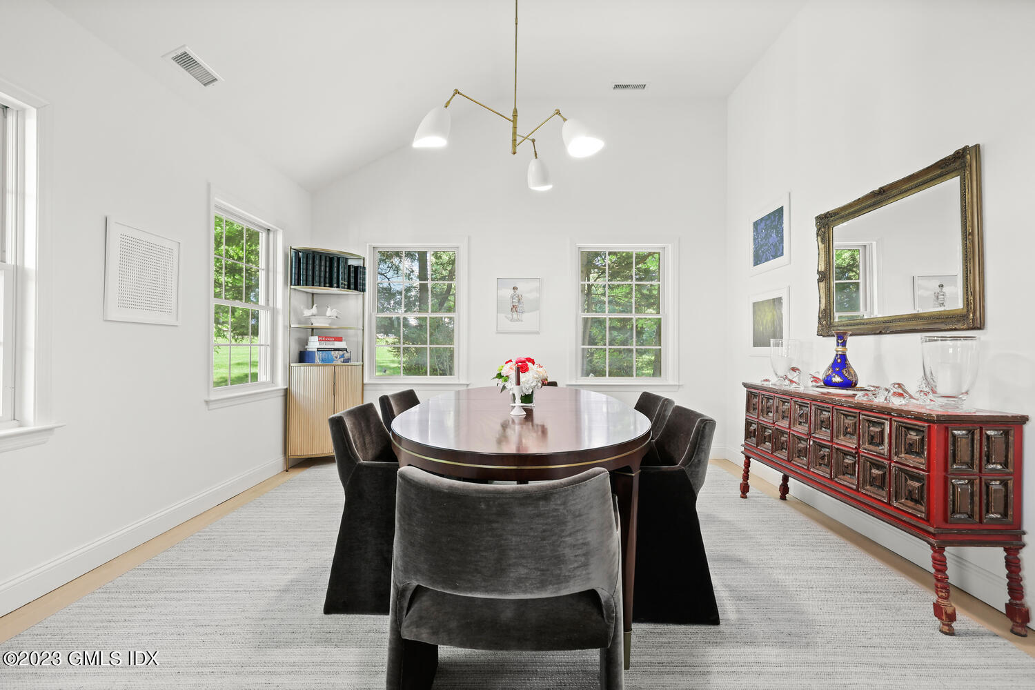 7 Cottontail Road Cos Cob, CT 06807 - Photo 7 of 39 a dining room with wooden floor a chandelier a wooden table and chairs