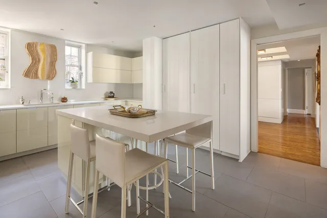 a kitchen with a sink cabinets and wooden floor