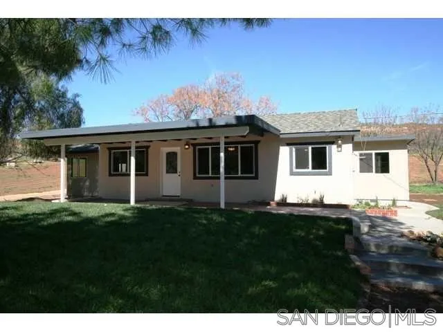5964 Dehesa Road El Cajon, CA 92019 - Photo 1 of 13 a front view of a house with a garden