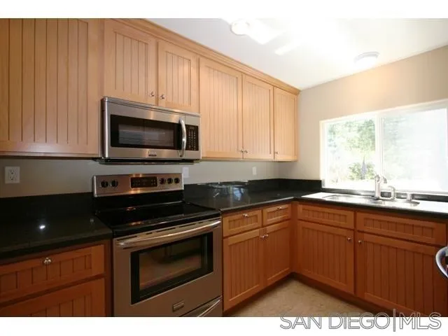 5964 Dehesa Road El Cajon, CA 92019 - Photo 7 of 13 a kitchen with appliances a sink and cabinets