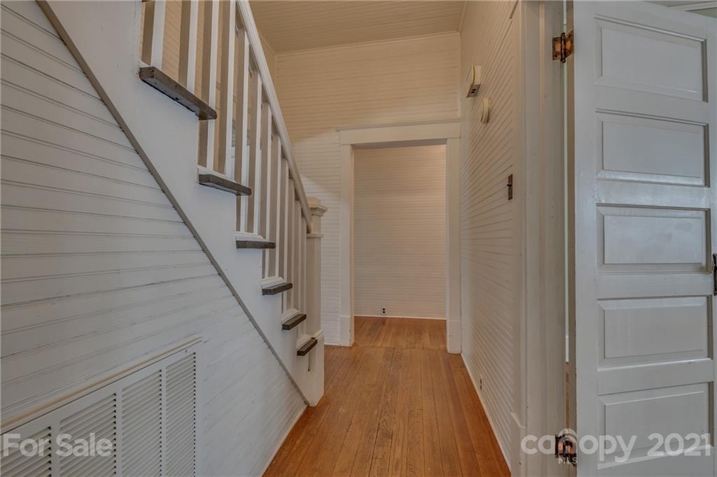 145 Pine Street Rutherfordton, NC 28139 - Photo 22 of 35 a view of a hallway with wooden floor and staircase