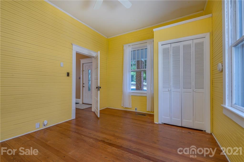145 Pine Street Rutherfordton, NC 28139 - Photo 8 of 35 a view of an empty room with wooden floor and a window