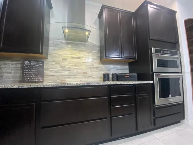 a kitchen with a cabinets and stainless steel appliances