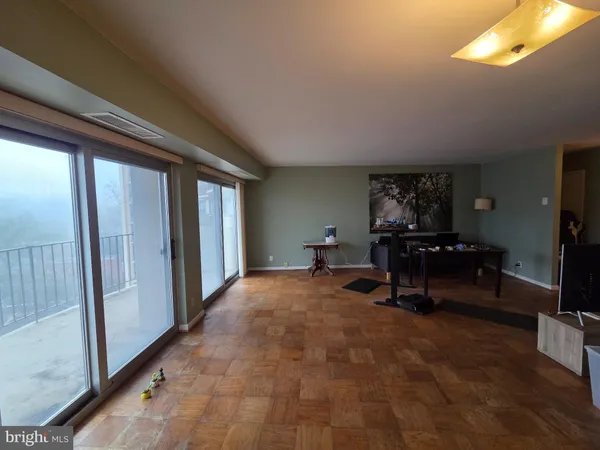 a view of a hallway to a livingroom with furniture