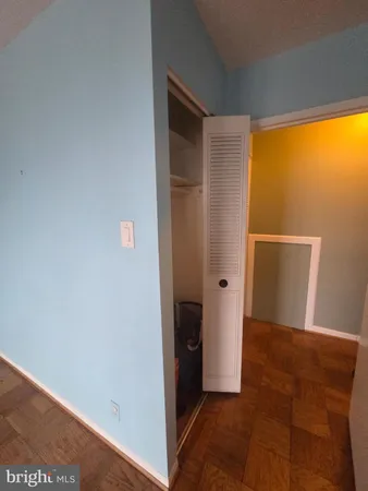 an empty room with windows and closet