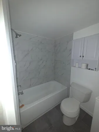 a bathroom with a toilet and bathtub