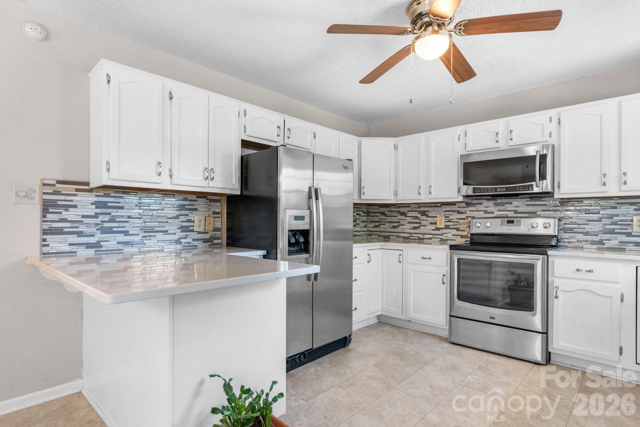 65 Pinewood Road Granite Falls, NC 28630 - Photo 13 of 42 a kitchen with cabinets stainless steel appliances and a counter space