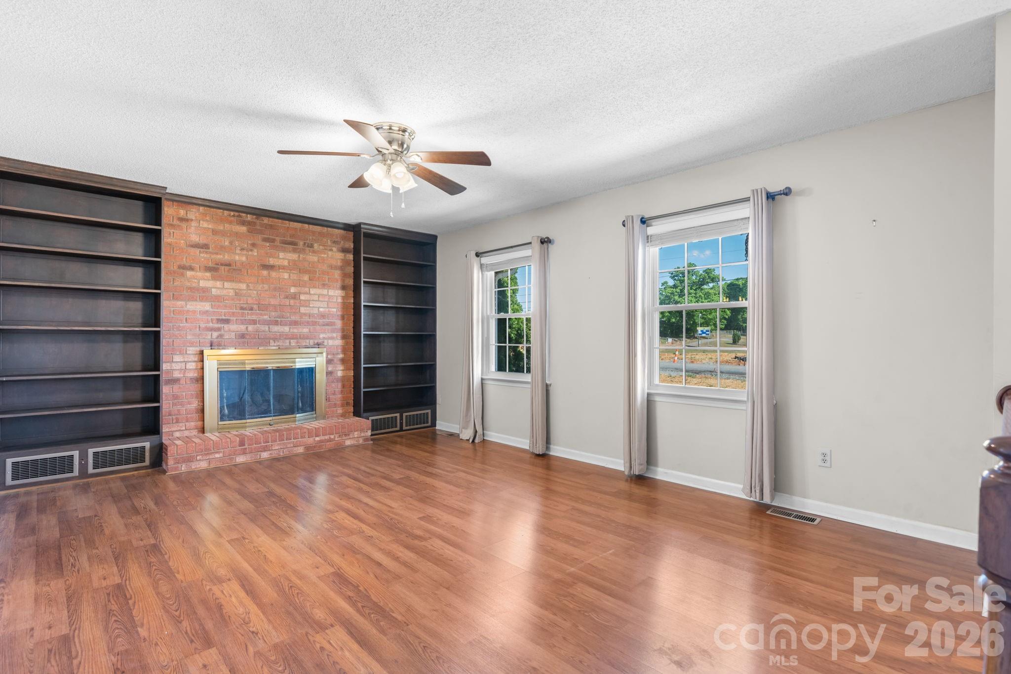 65 Pinewood Road Granite Falls, NC 28630 - Photo 17 of 42 a view of an empty room with a window and wooden floor