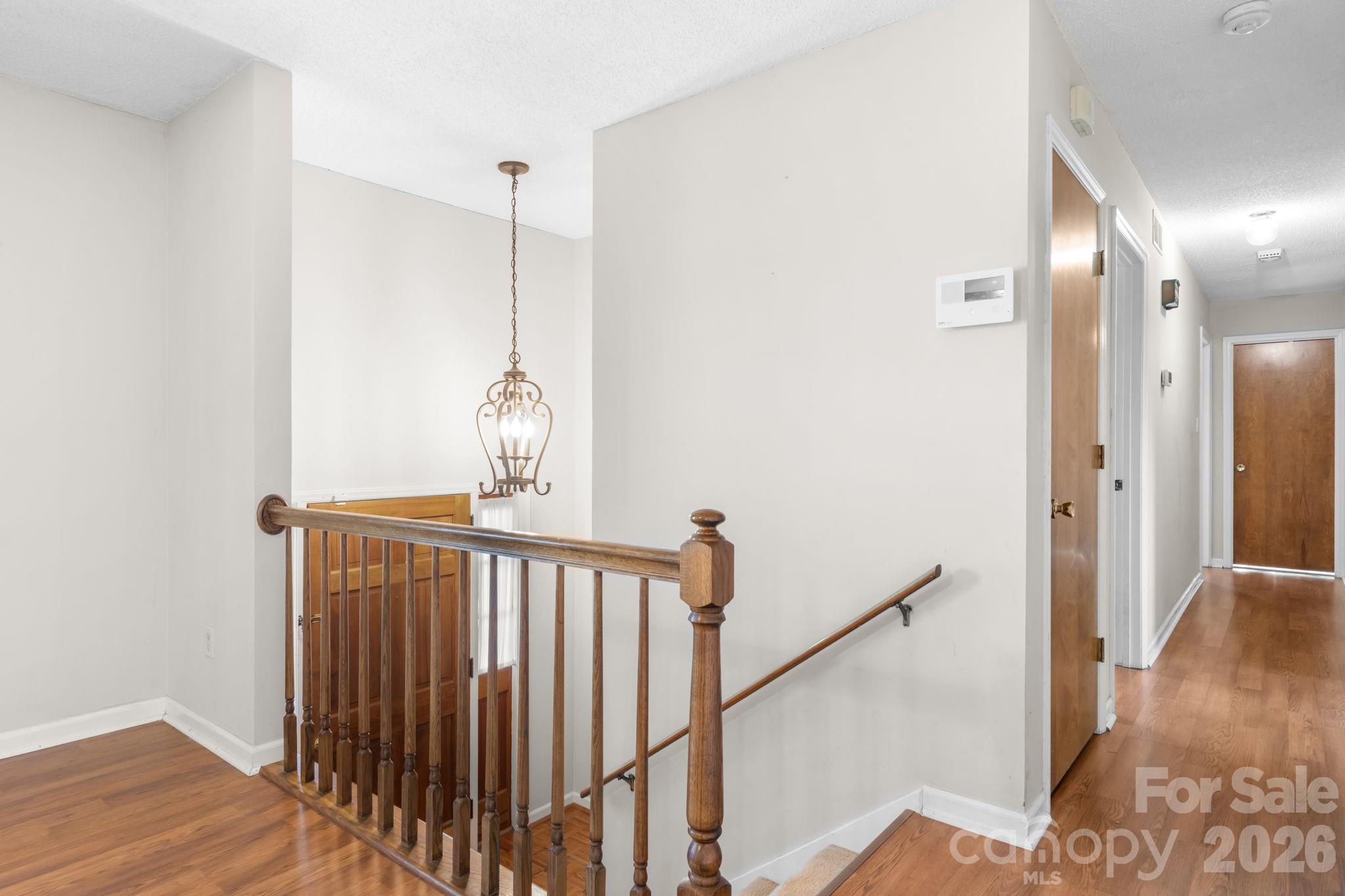 65 Pinewood Road Granite Falls, NC 28630 - Photo 20 of 42 a view of a hallway with wooden floor and stairs