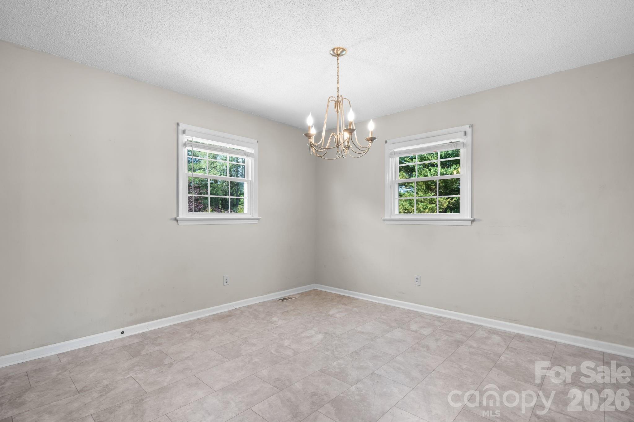 65 Pinewood Road Granite Falls, NC 28630 - Photo 21 of 42 en empty room with windows and chandelier