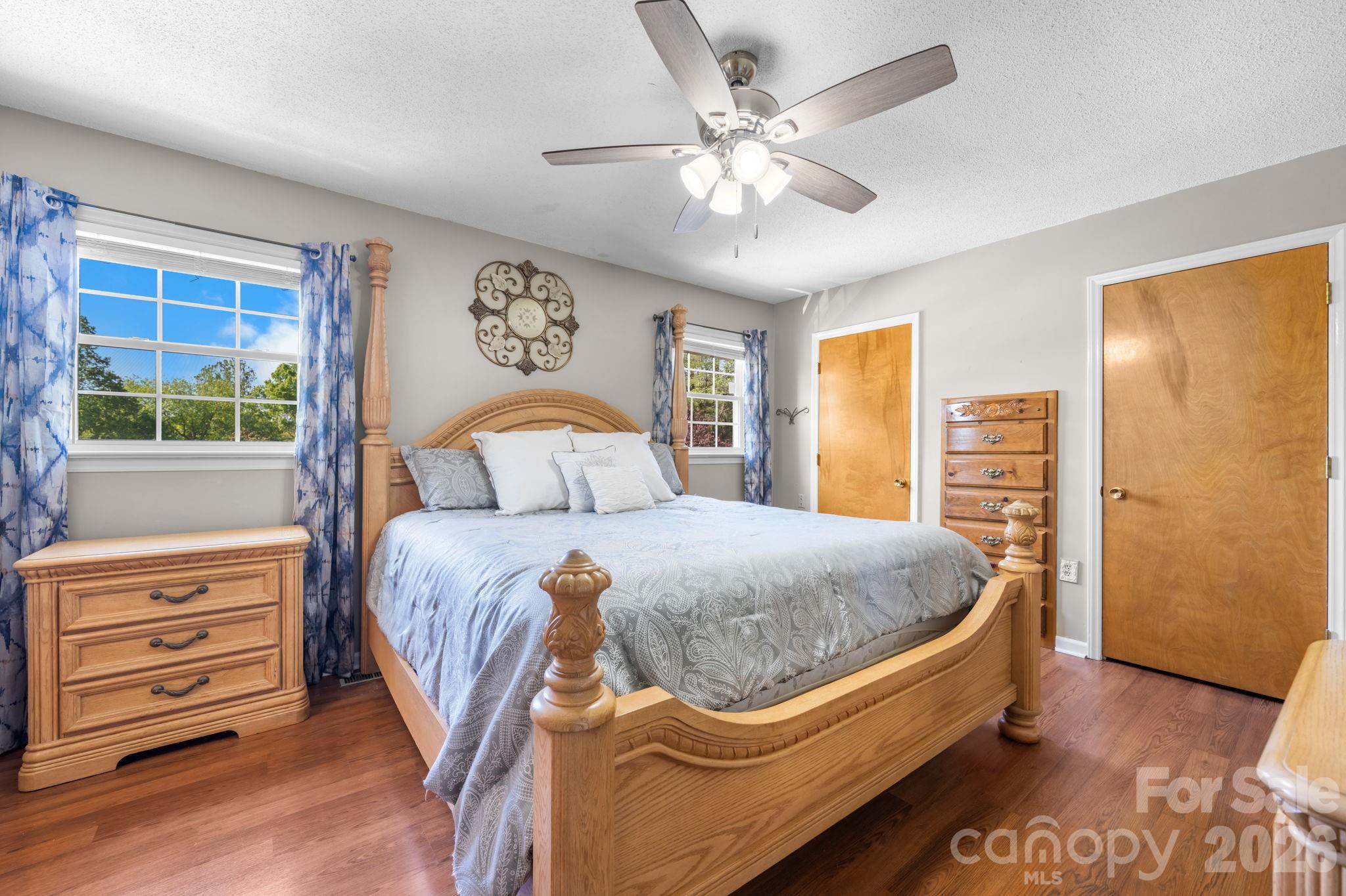 65 Pinewood Road Granite Falls, NC 28630 - Photo 23 of 42 a bedroom with a bed and a chandelier