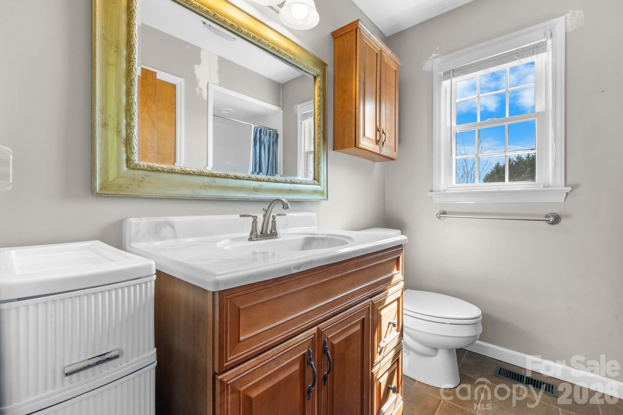 65 Pinewood Road Granite Falls, NC 28630 - Photo 24 of 42 a bathroom with a sink a toilet and a mirror
