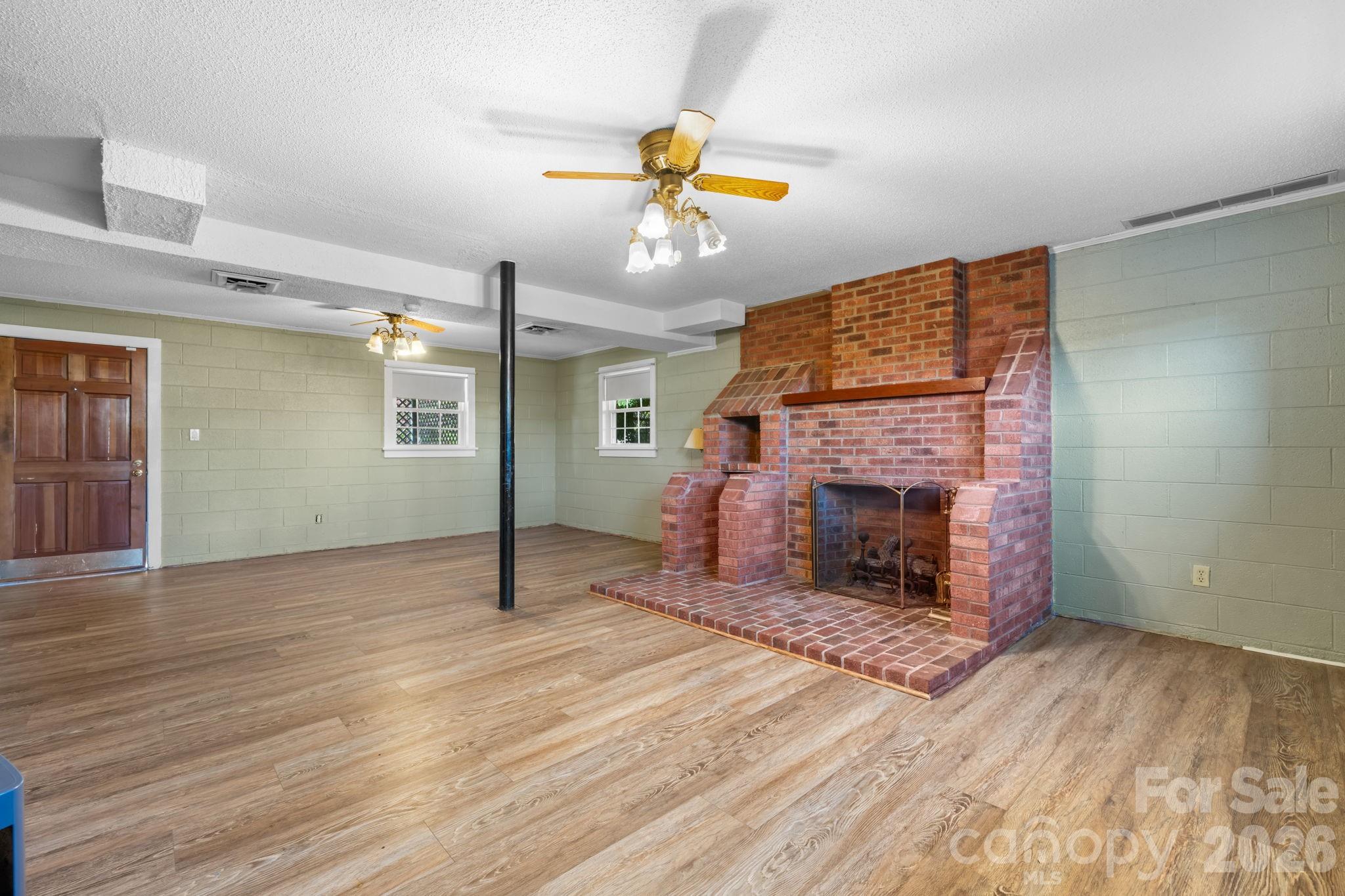 65 Pinewood Road Granite Falls, NC 28630 - Photo 29 of 42 a living room with hard wood floors and a fireplace