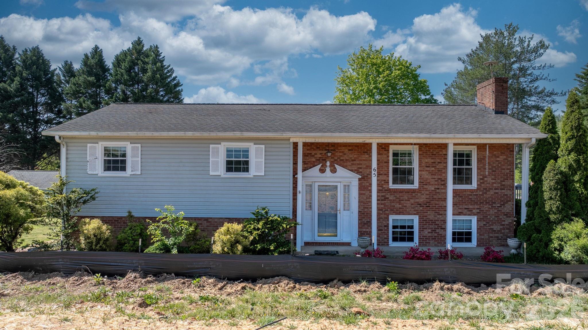 65 Pinewood Road Granite Falls, NC 28630 - Photo 3 of 42 a front view of a house with a yard