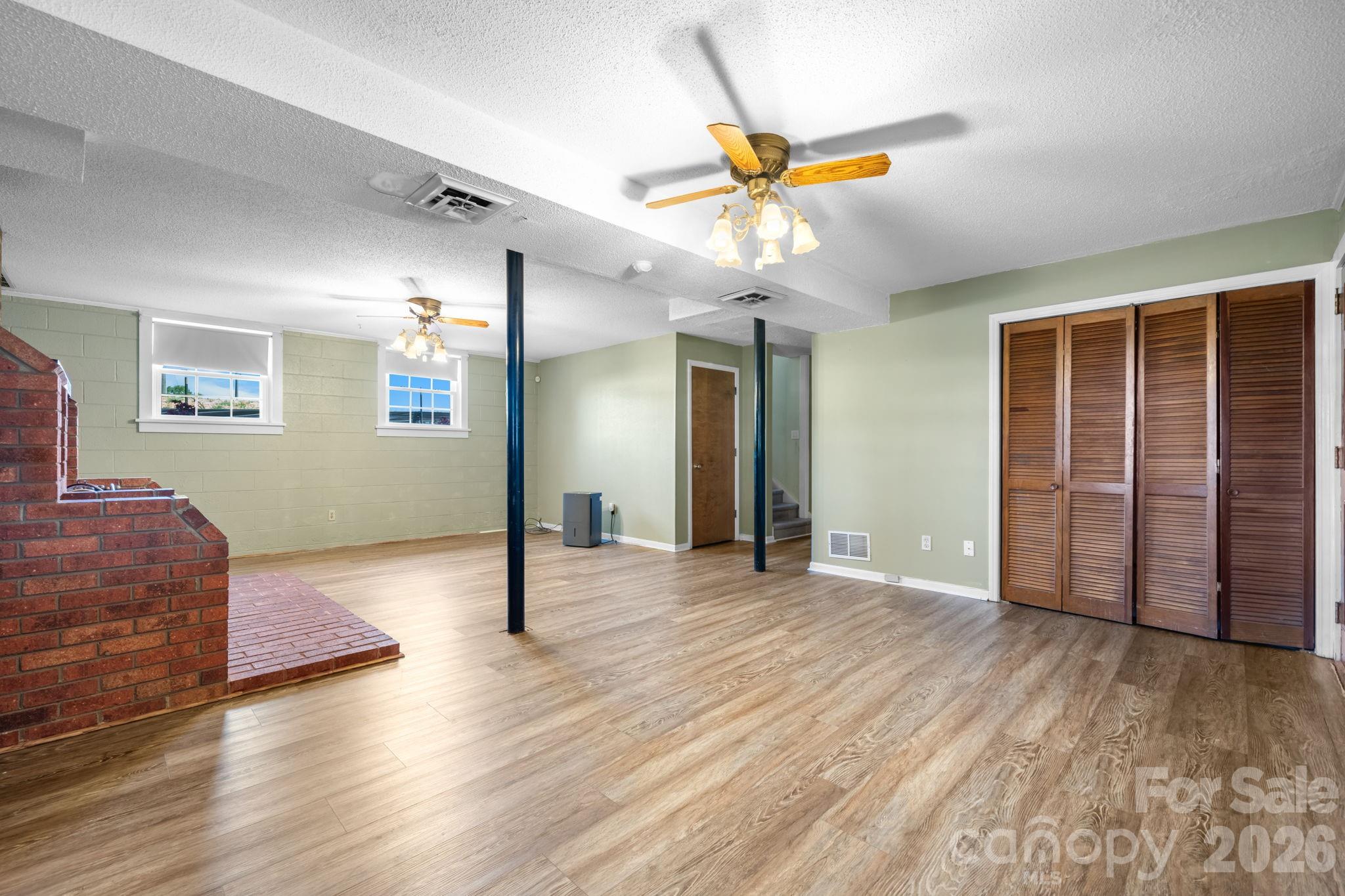 65 Pinewood Road Granite Falls, NC 28630 - Photo 31 of 42 a view of an empty room with wooden floor and a ceiling fan