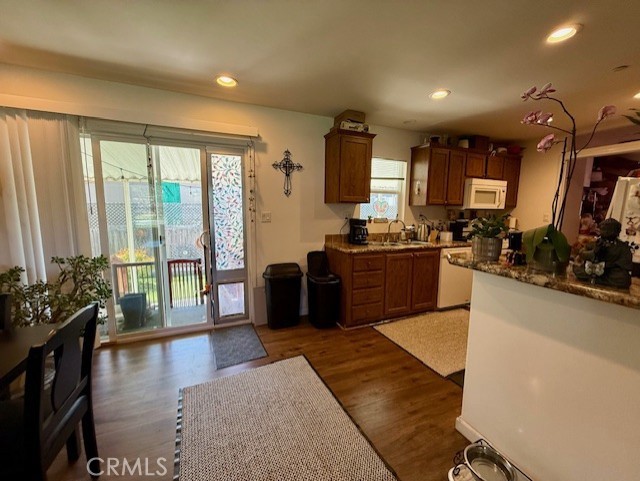 9200 Pinewood Court Atascadero, CA 93422 - Photo 11 of 26 a large living room with stainless steel appliances granite countertop a refrigerator a sink dishwasher a dining table and chairs with wooden floor