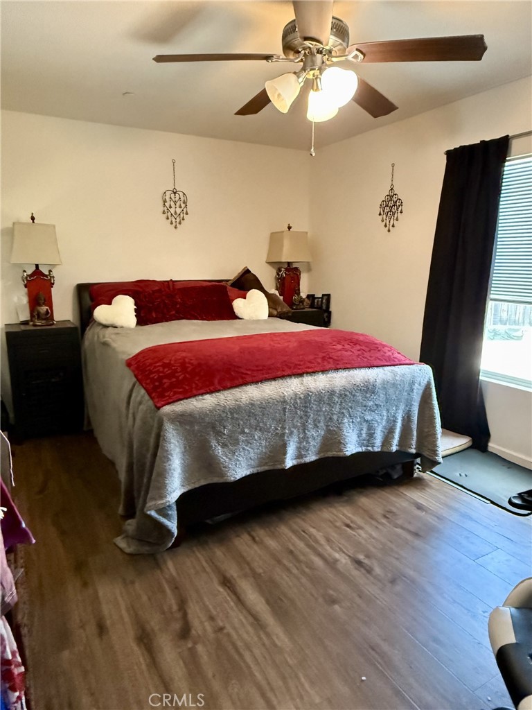 9200 Pinewood Court Atascadero, CA 93422 - Photo 17 of 26 a bedroom with a bed and wooden floor
