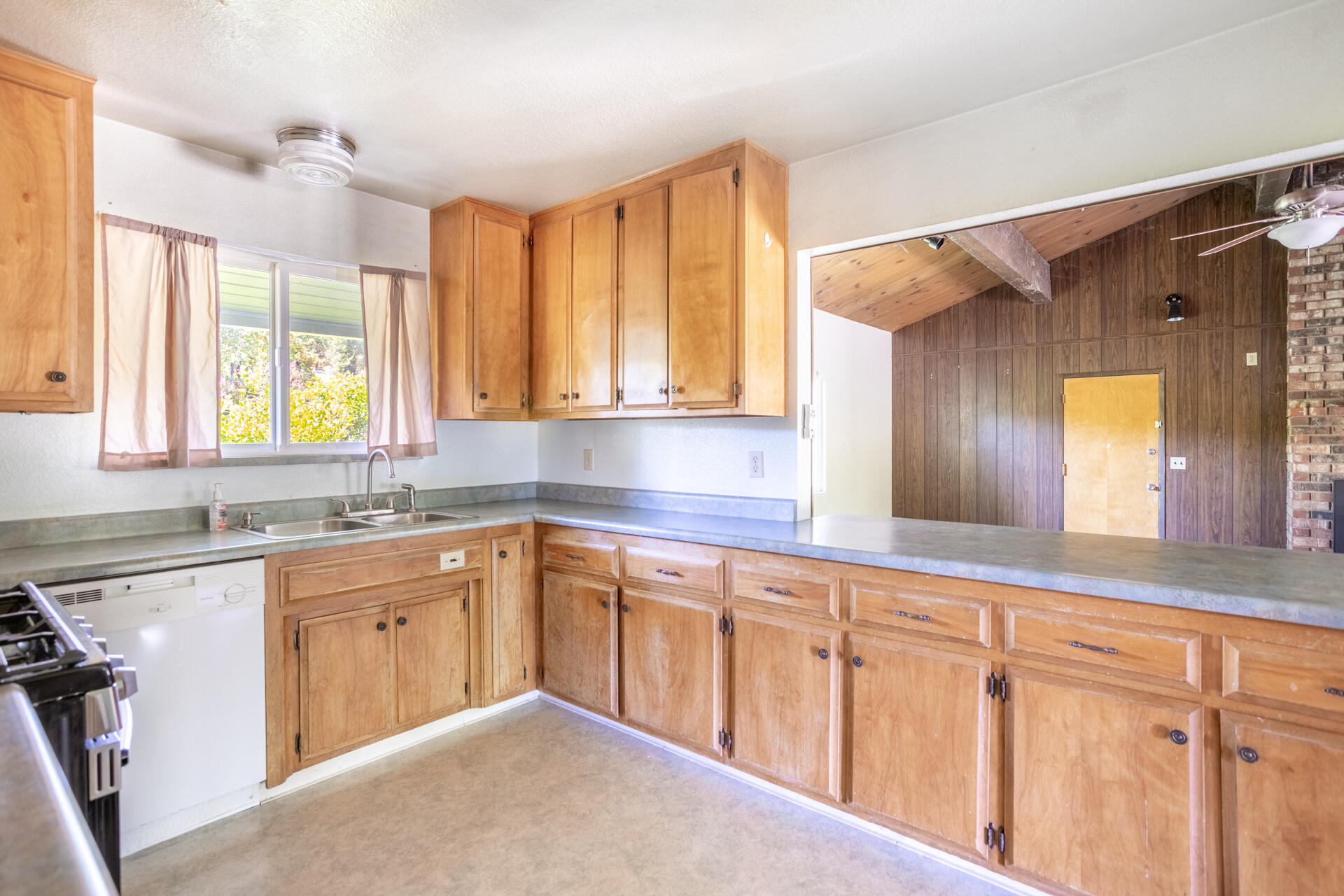 8415 Valley View Road Redding, CA 96001 - Photo 12 of 31 a kitchen with wooden cabinets sink and window