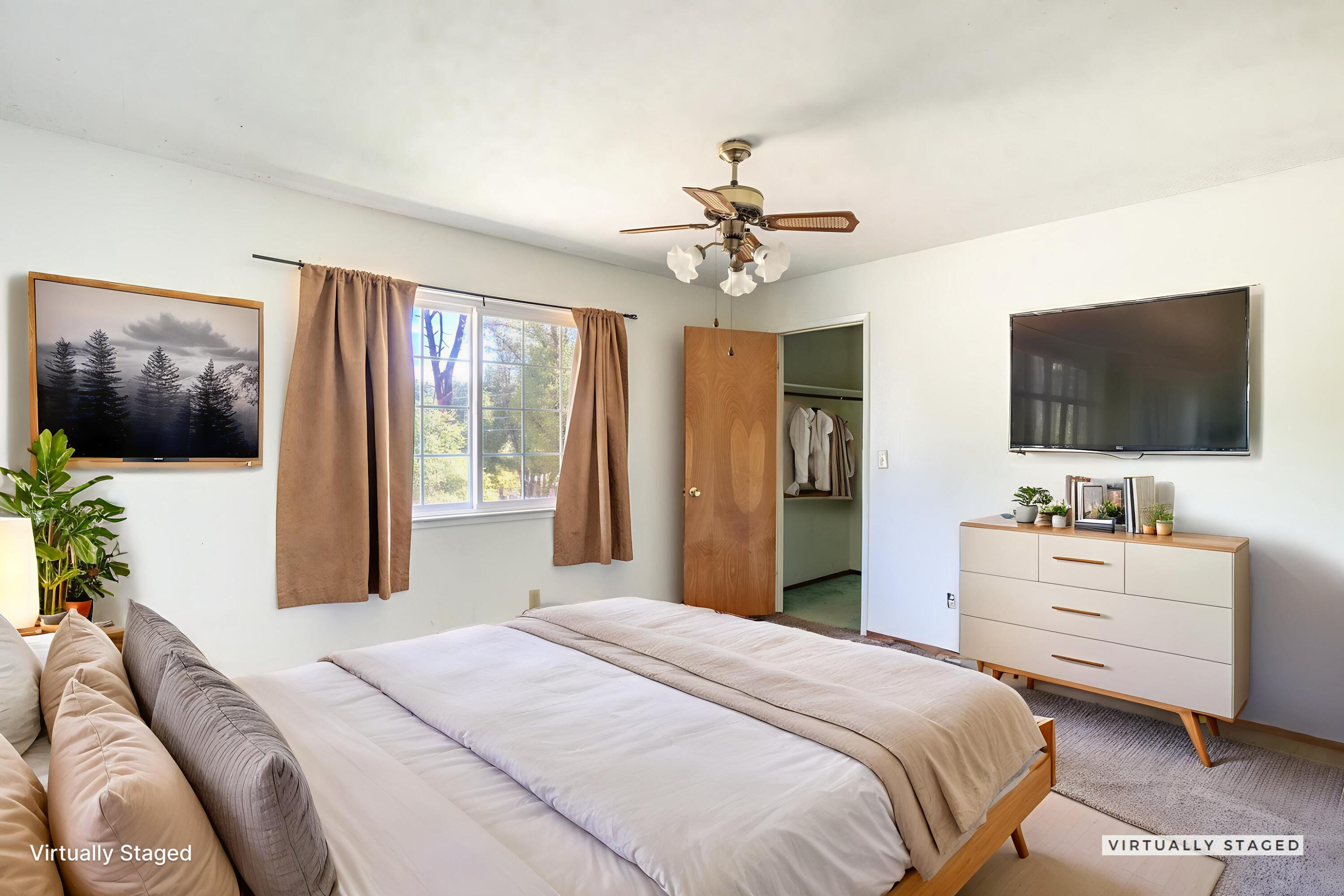 8415 Valley View Road Redding, CA 96001 - Photo 17 of 31 a bedroom with a bed and a flat screen tv