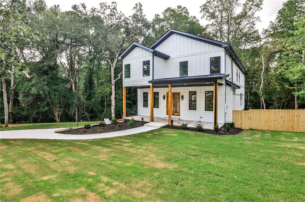 a view of a house with a yard and sitting area