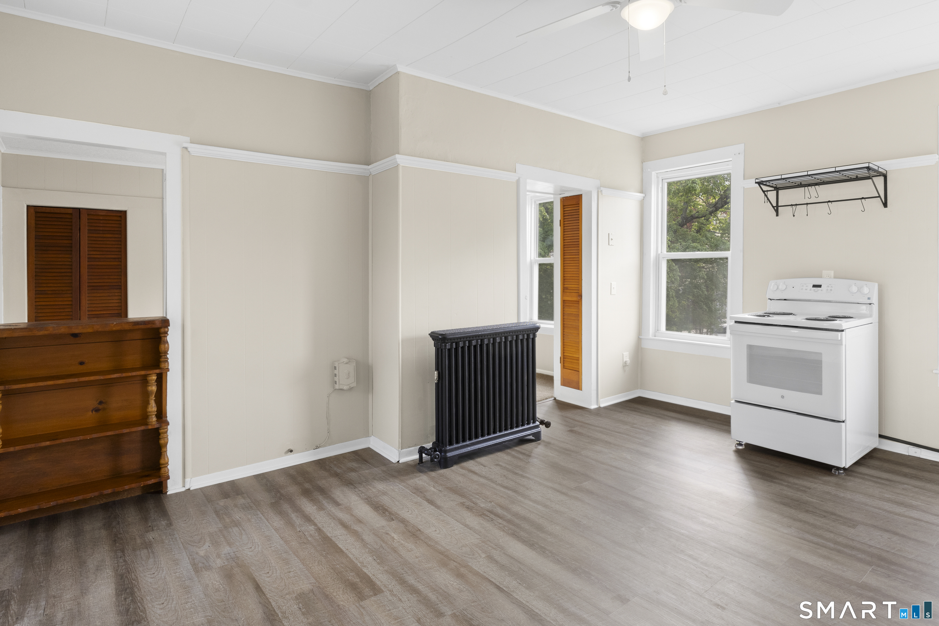 198 South Main Street Putnam, CT 06260 - Photo 1 of 21 an empty room with wooden floor cabinet and windows