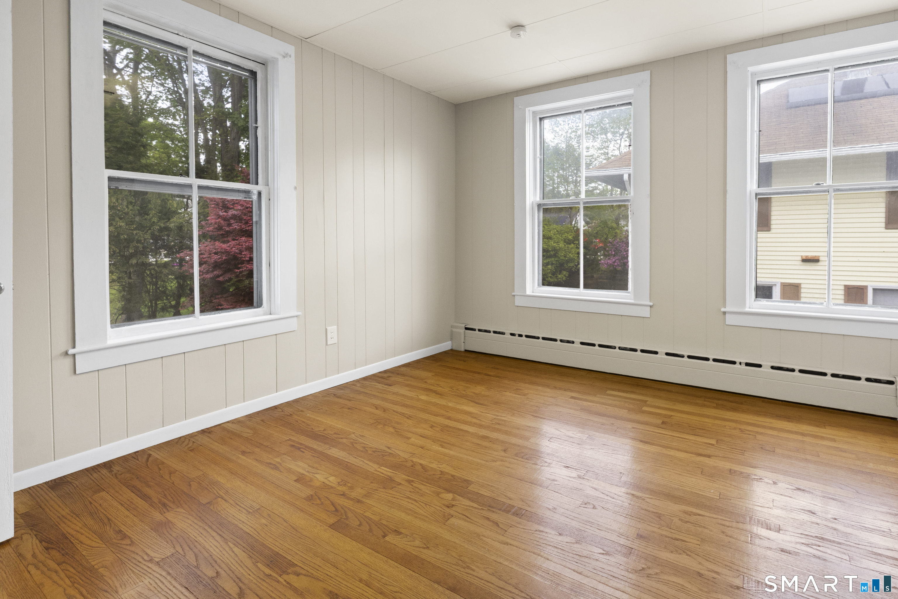 198 South Main Street Putnam, CT 06260 - Photo 15 of 21 a view of an empty room with wooden floor and windows